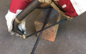 cutting rebar by a hacksaw
